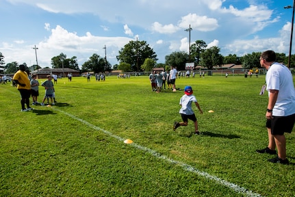 Children practice route running drills during the Andre Roberts Pro Camp, July 15, 2013, at Joint Base Charleston - Weapons Station, S.C. More than 100 base children attended the Andre Roberts Pro Camp on July 15-16. The camp was paid for by Roberts, enabling the children to attend for free. (U.S. Air Force photo/ Senior Airman George Goslin)