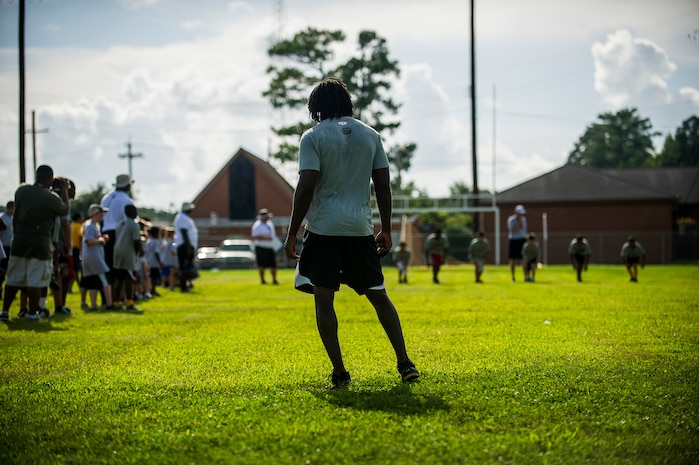 Andre Roberts, Arizona Cardinals wide receiver, waits at the 40 yard dash finish line to judge the winners during the Andre Roberts Pro Camp, July 15, 2013, at Joint Base Charleston - Weapons Station, S.C. More than 100 base children attended the Andre Roberts Pro Camp on July 15-16. The camp was paid for by Roberts, enabling the children to attend for free. (U.S. Air Force photo/ Senior Airman George Goslin)