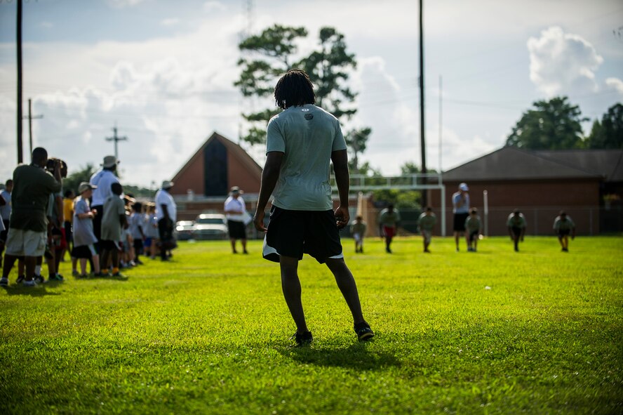 Andre Roberts, Arizona Cardinals wide receiver, waits at the 40 yard dash finish line to judge the winners during the Andre Roberts Pro Camp, July 15, 2013, at Joint Base Charleston - Weapons Station, S.C. More than 100 base children attended the Andre Roberts Pro Camp on July 15-16. The camp was paid for by Roberts, enabling the children to attend for free. (U.S. Air Force photo/ Senior Airman George Goslin)