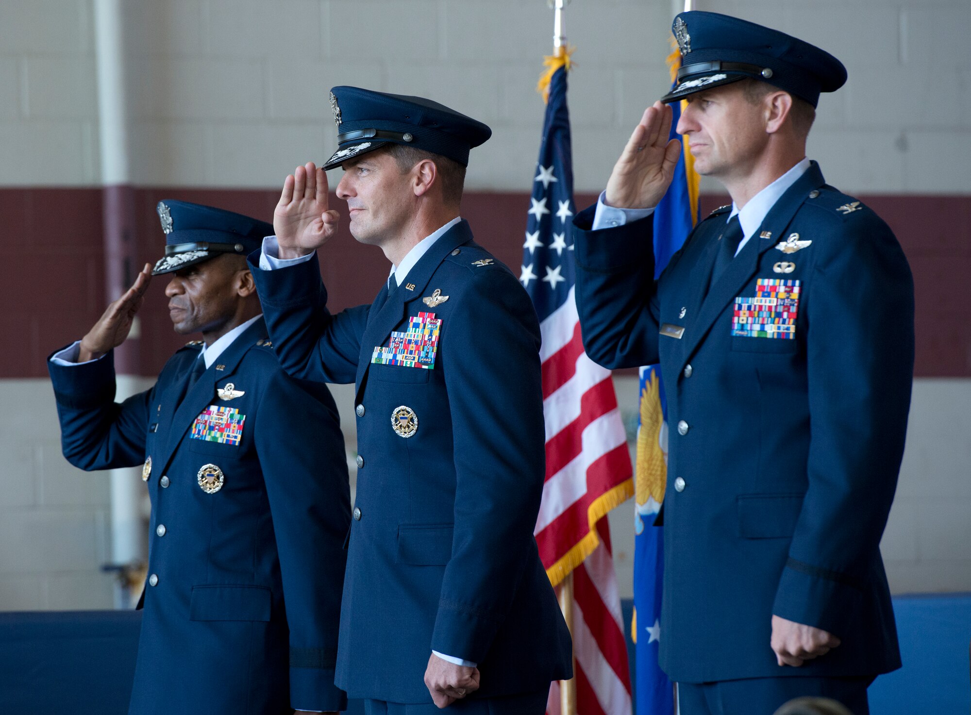 Lt. Gen. McDew, 18th Air Force commander salutes during the change of command ceremony with Sones and Martin.  (U.S. Air Force photo/Heide Couch)