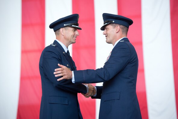 Col. Corey Martin, left, 60th Air Mobility Wing commander, and outgoing commander, Col. Dwight Sones, shake hands during the change of command ceremony July 16, 2013 at Travis.  (U.S. Air Force photo/Ken Wright)
