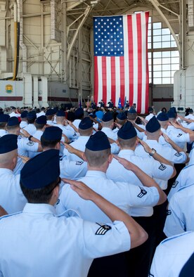 Airmen salute the flag during the 60th Air Mobility Wing change of command ceremony July 16, 2013. (U.S. Air Force photo/Ken Wright)