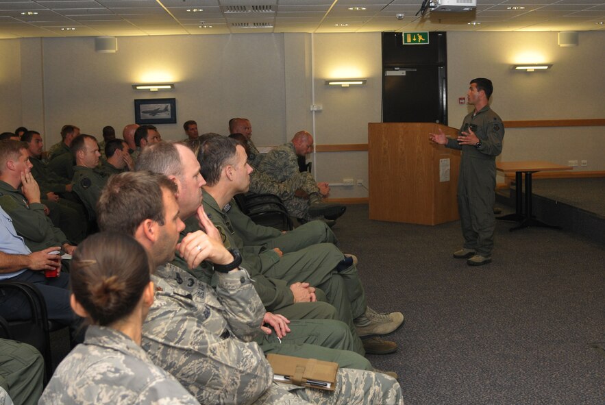 Lt. Col. Christopher Goodyear, 7th Special Operations Squadron CV-22 operations officer from Charleston, S.C., briefs members of the 100th Operations Group and the 48th OG at RAF Lakenheath, about the CV-22B Ospreys during a Cross Talk July 19, 2013, in building 809 on RAF Mildenhall, England. One of the topics discussed at the Cross Talk meeting was the 352nd Special Operations Group’s planned reception of 10 total CV-22B Ospreys by 2014 as part of its expansion. (U.S. Air Force photo by Airman 1st Class Kelsey Waters/Released)
