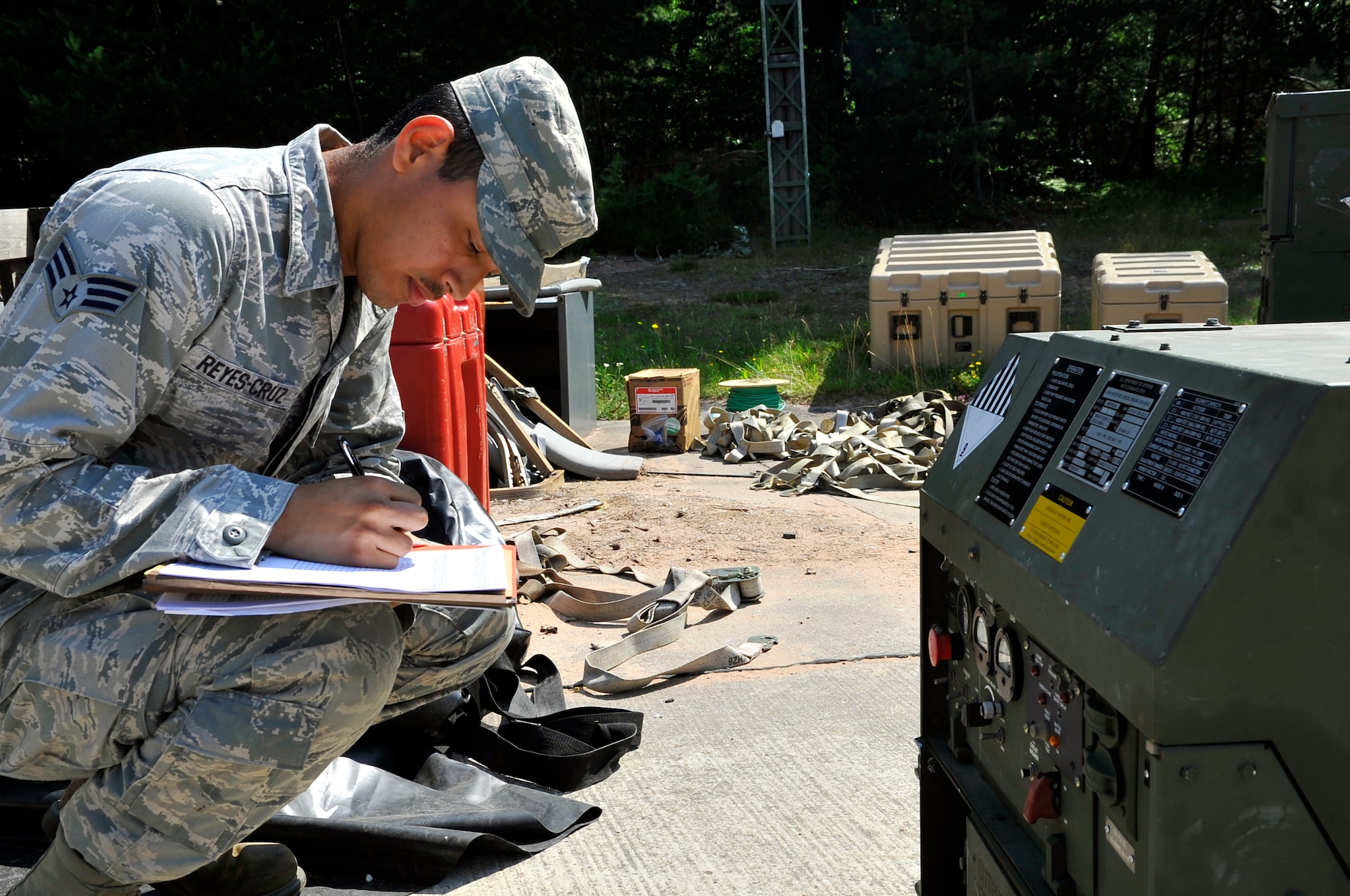 Senior Airman Denis Reyes-Cruz, 1st Combat Communications Squadron electrician, performs a check on a generator during a training exercise, July 10, 2013, Ramstein Air Base, Germany. The exercise was held in order to ensure Airmen can perform the mission outside of a normal training environment. (U.S. Air Force photo/Airman 1st Class Trevor Rhynes)