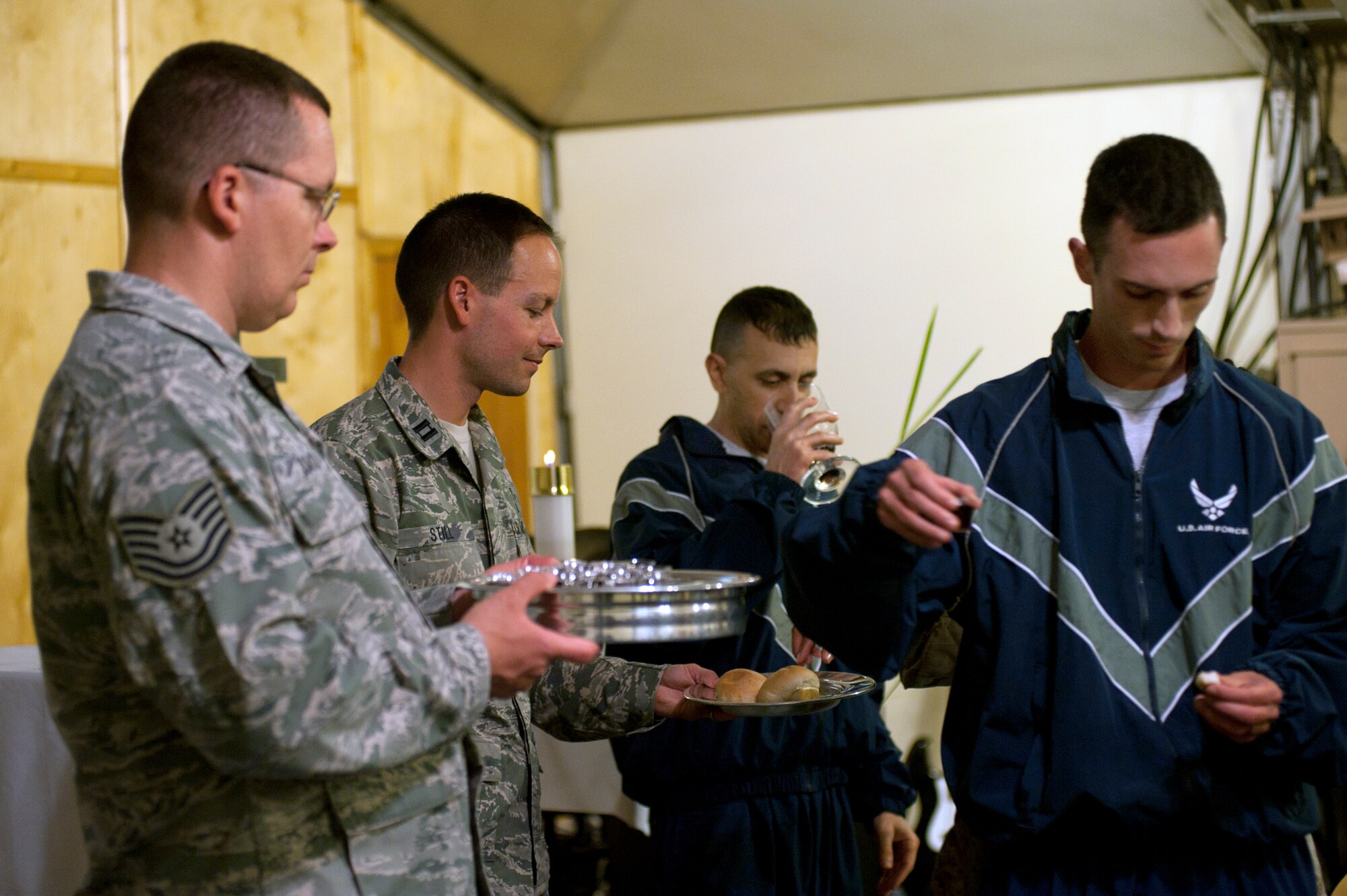 Military members in the Physical Training Uniform partake of Holy Communion during a Protestant chapel service at Transit Center at Manas, Kyrgyzstan, July 14, 2013. In the Christian religion, Holy Communion is based on the Last Supper of Jesus Christ, including a sip of either grape juice or wine, said to represent the blood of Christ. (U.S. Air Force photo/Staff Sgt. Robert Barnett)