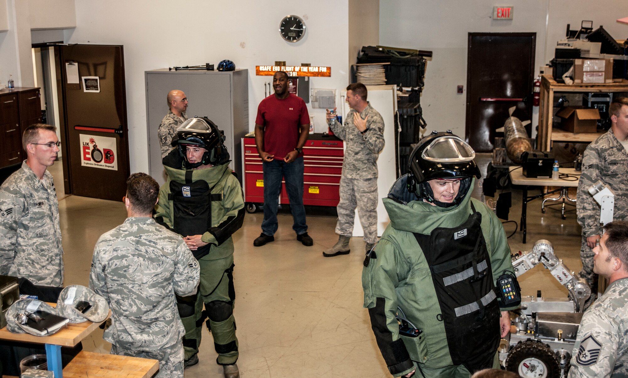 Col. Craig Wills, 39th Air Base Wing commander, right, and Maj. Matthew Welling, 39th Civil Engineer Squadron commander, are given tips for wearing a bomb suit by 39th CES explosive ordnance disposal members during the wing commander’s immersion with the EOD flight July 18, 2013, at Incirlik Air Base, Turkey. Wills and Welling were given a crash course on the bomb suit and an EOD robot. (U.S. Air Force photo by Senior Airman Anthony Sanchelli/Released)