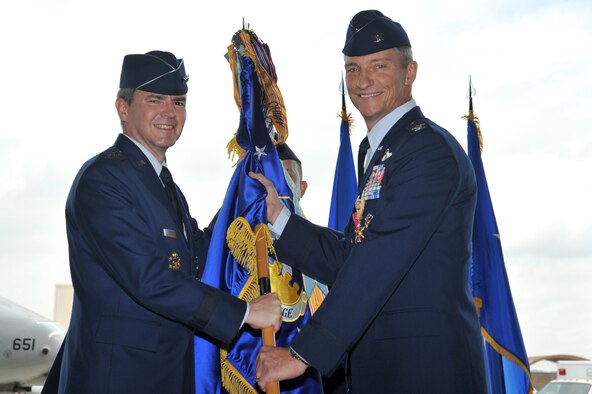 Col. Patrick McKenzie relinquishes command of the 51st Fighter Wing during a change of command ceremony at Osan Air Base, Republic of Korea, July 19, 2013.   McKenzie has served as the 51st FW's commander since July 14, 2011. (U.S. Air Force photo/Staff Sgt. Emerson Nuñez)