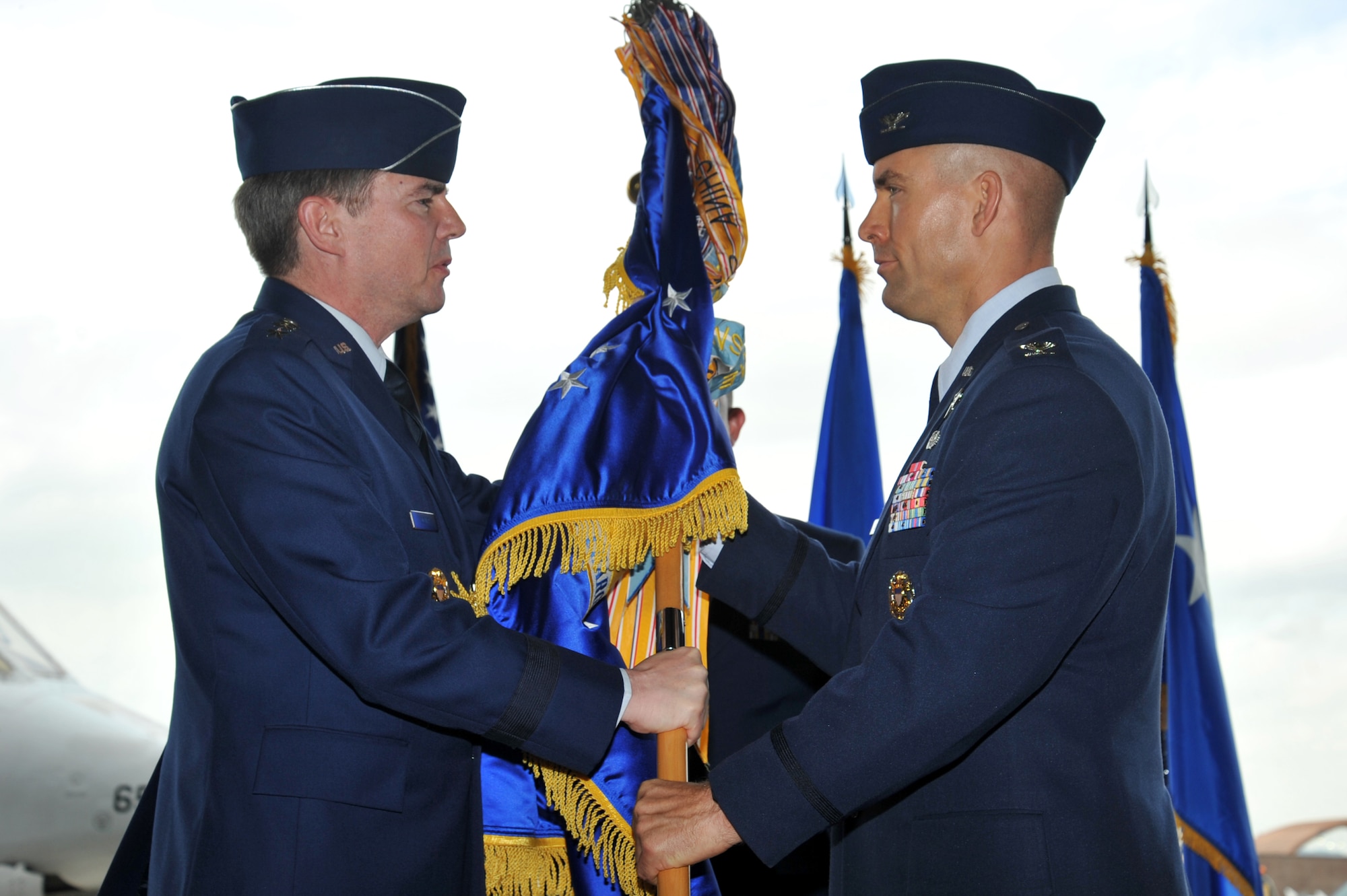 Lt. Gen. Jan-Marc Jouas, 7th Air Force commander, transfers command of the 51st Fighter Wing to Col. Brook Leonard during a change of command ceremony at Osan Air Base, Republic of Korea, July 19, 2013.  As commander he is responsible for ensuring the wing is ready to defend Osan Air Base, execute combat operations, and receive follow-on forces. (U.S. Air Force photo/Staff Sgt. Emerson Nuñez)