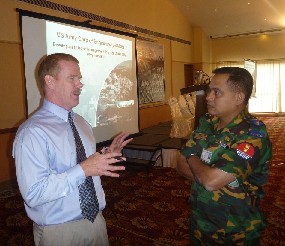 Sean Dowling, USACE-Pacific Ocean Division's operations officer, discusses debris reduction techniques with Lt. Col. Saiful Islam from the Bangladesh Army.