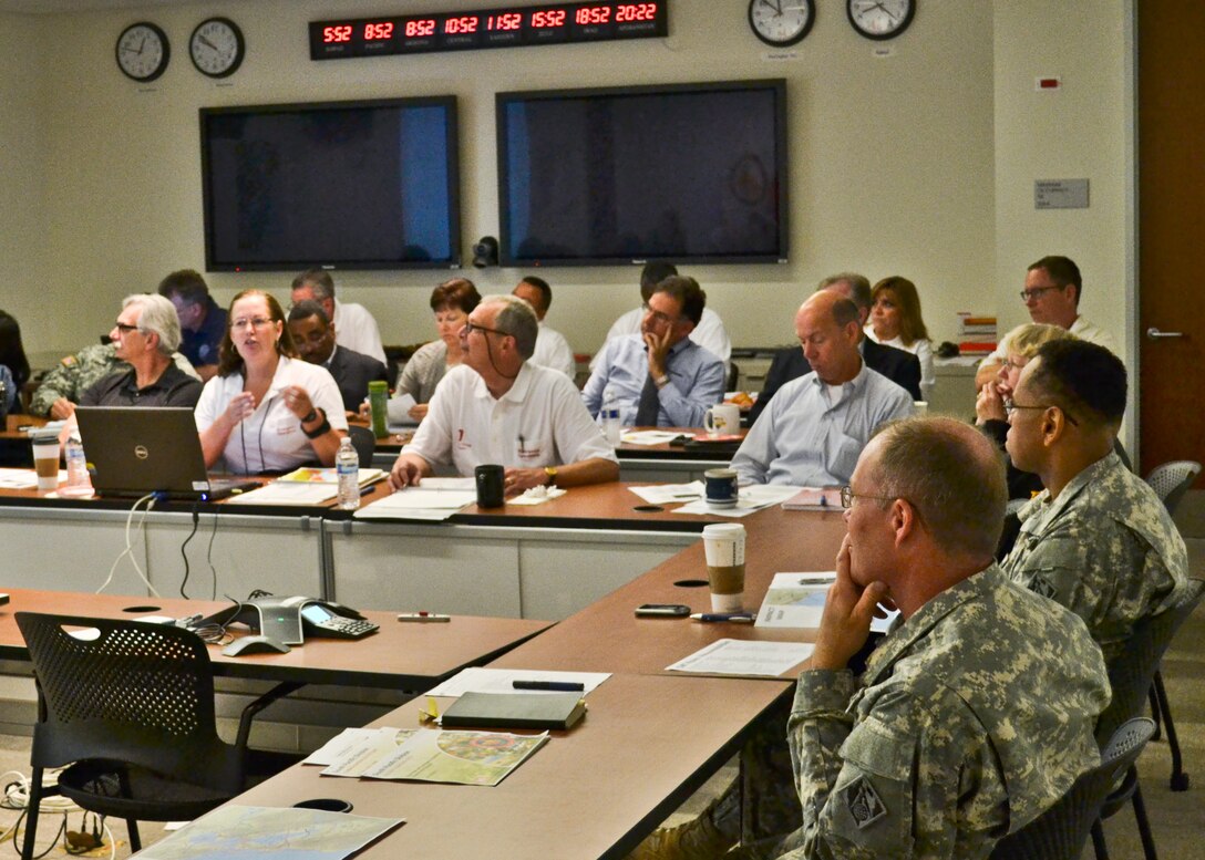 Amy Aton, a member of South Pacific Division's Readiness and Contingency Operations staff, briefs division leaders during the annual Golden Guardian training held here at SPD Headquarters in San Francisco, Calif., July 17, 2013. The training, designed to provide Corps employees with an overview of response capabilities in the event of a local emergency or natural disaster, emphasized the coordination between the Corps of Engineers and the Federal Emergency Management Agency. (U.S. Army photo by Randy Gon/Released)