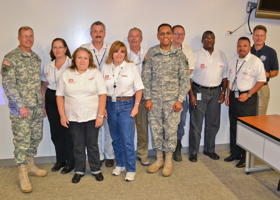 Col. Dave Turner (center), South Pacific Division Commander, and Col. Andrew Nelson (left), South Pacific Division Deputy Commander, stand with the Readiness and Contingency Operations (RCO) staff after the annual Golden Guardian held here at SPD Headquarters in San Francisco, Calif., July 17, 2013. The training, designed to provide Corps employees with an overview of response capabilities in the event of a local emergency or natural disaster, emphasized coordination between the Corps of Engineers and the Federal Emergency Management Agency. (U.S. Army photo illustration by Randy Gon/Released)