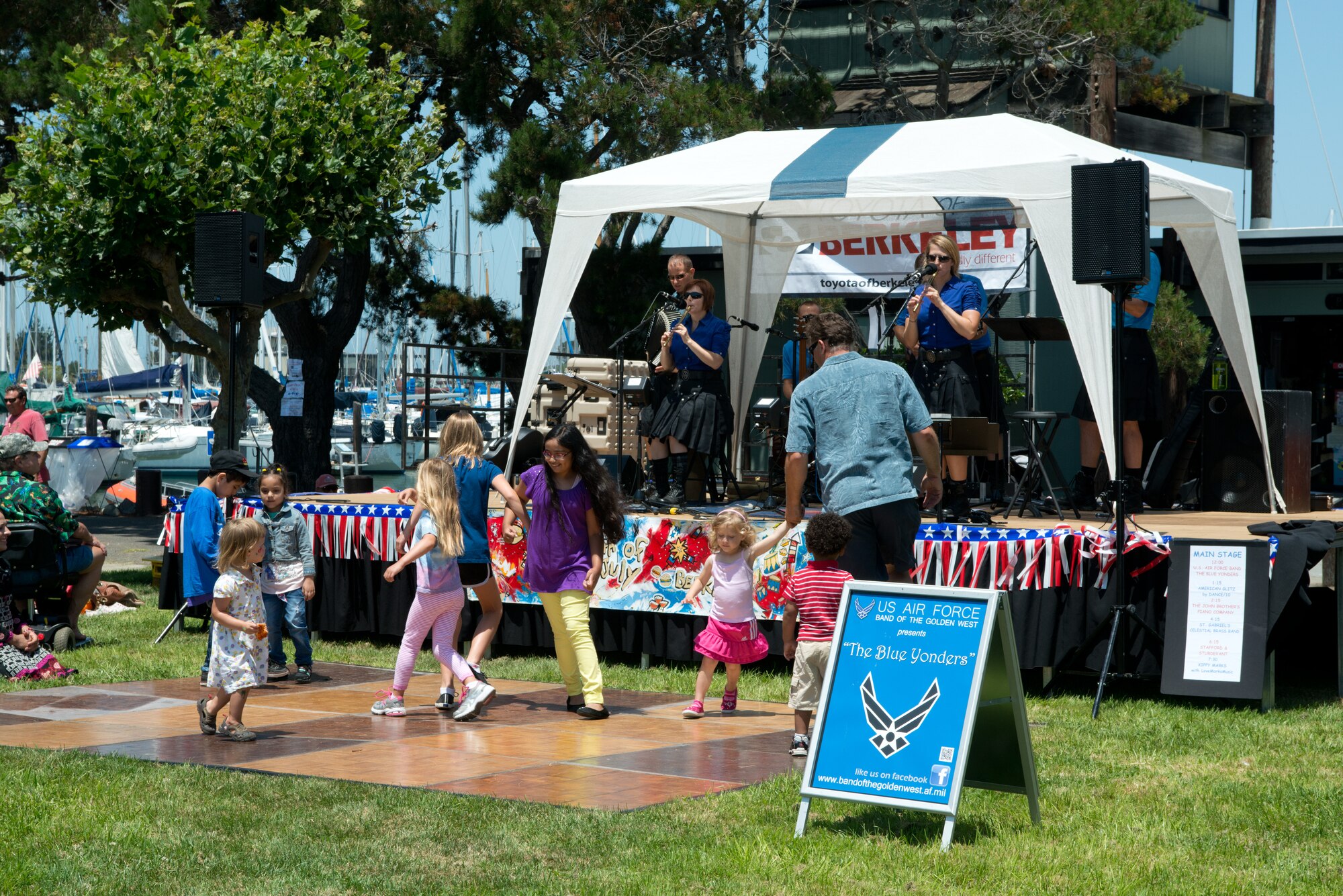Children dance during a performance by The Blue Yonders, the newest ensemble of the USAF Band of the Golden West, stationed at Travis Air Force Base, Calif.  The Blue Yonders, gearing up for their upcoming deployment to support troop morale, nation building and U.S. Embassy outreach initiatives, were invited to perform their unique Irish folk-rock music to help the local community celebrate Independence Day at the marina in Berkeley, Calif. on July 4, 2013.(U.S. Air Force photo/ )