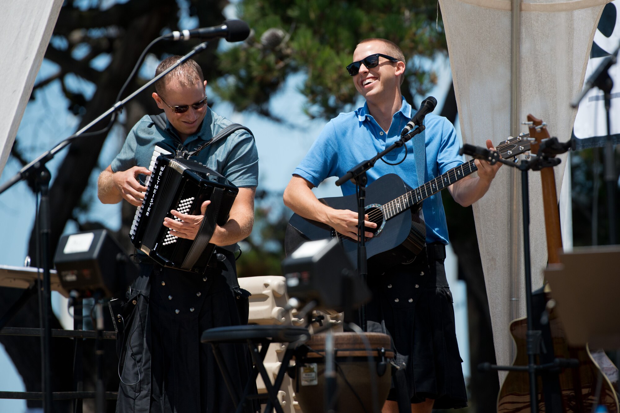Playing accordion and guitar, Staff Sgt. Brandon May and Airman First Class Benjamin Johnson, USAF Band of the Golden West, harness the power of music to showcase Air Force excellence to the crowd gathered for the live Independence Day show in Berkeley, Calif. Jul 4, 2013. May and Johnson are members of The Blue Yonders, one of the ensembles of the USAF Band of the Golden West stationed at Travis AFB, Calif.  The Blue Yonders, comprised of seven active duty AF band members sporting authentic kilts and playing traditional instruments, specialize in Irish folk-rock and pop music favorites.  They are soon to deploy in support of troop morale, nation building and US Embassy outreach initiatives in overseas locations. (U.S. Air Force photo/ )