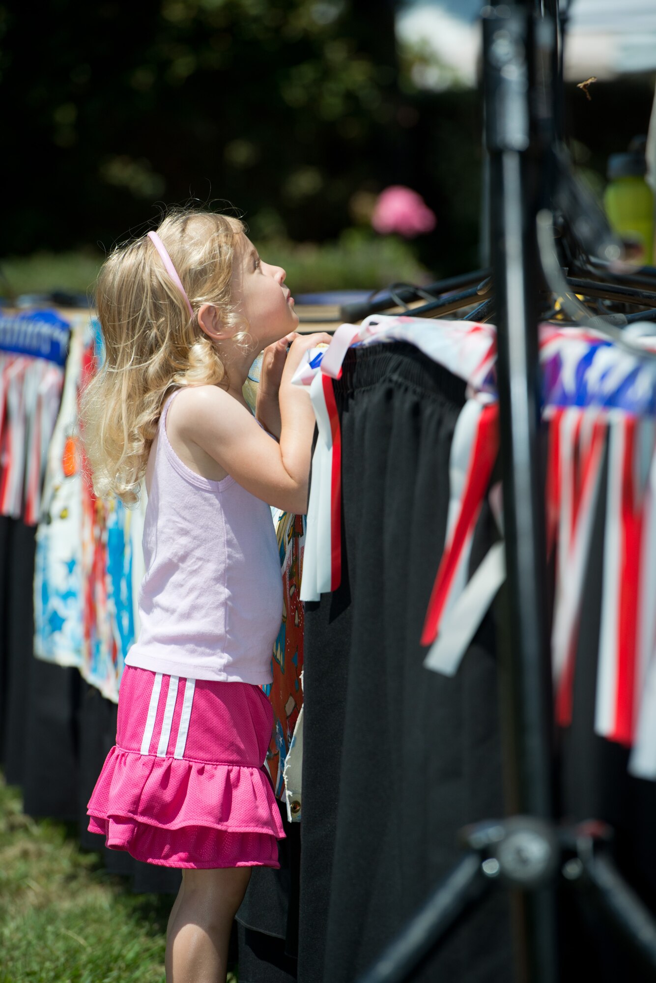 A young audience member gets close to the action as she hugs the stage where The Blue Yonders performed July 4, 2013, in Berkeley, Calif.  The Blue Yonders, one of the ensembles comprising the USAF Band of the Golden West stationed at Travis Air Force Base, Calif., entertained the outdoor crowd gathered to enjoy the live music line up in celebration of America’s Independence Day. (U.S. Air Force photo/ )