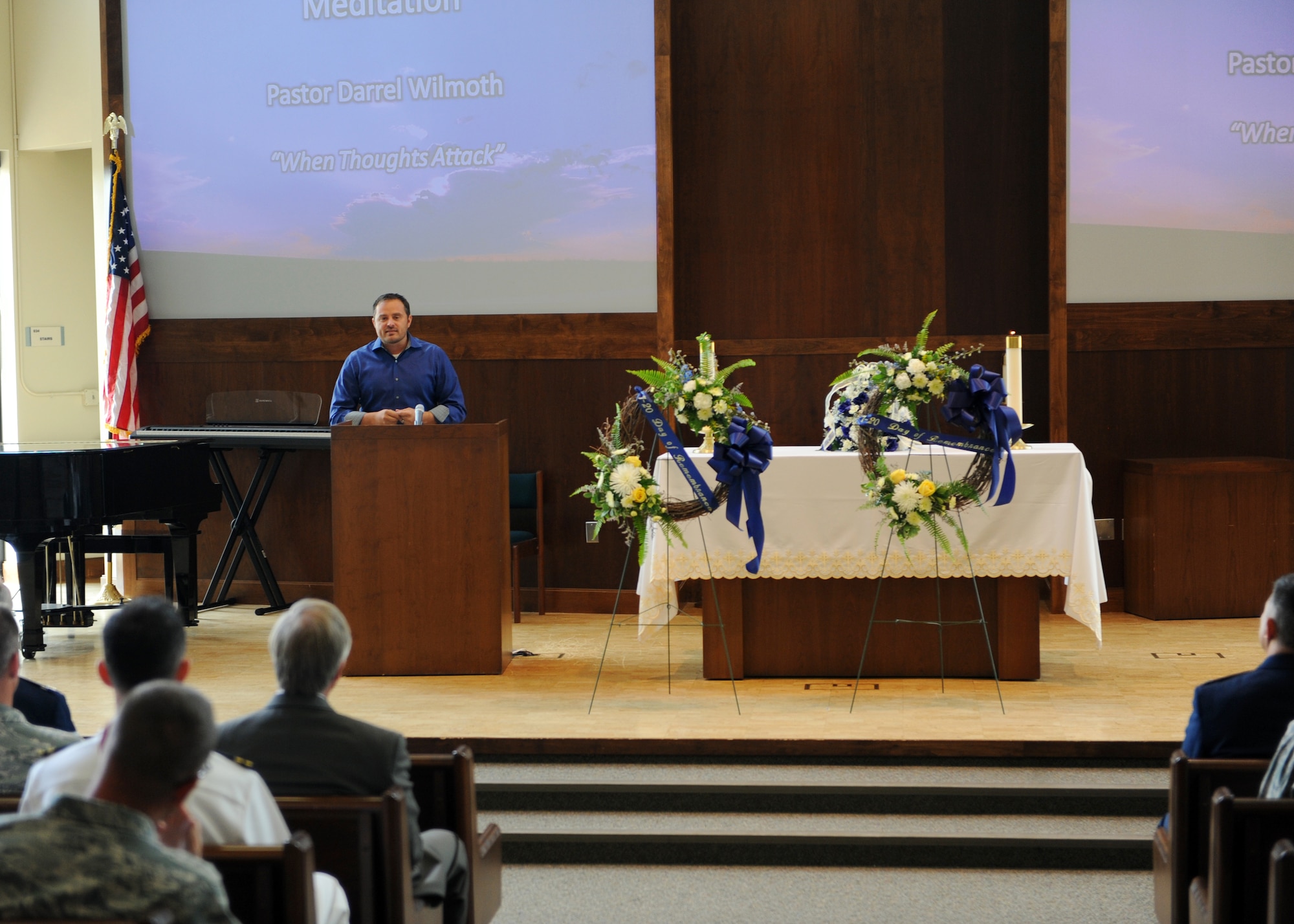 Pastor Darrel Wilmoth, Front Range Calvary, speaks about the Aurora Theater tragedy July 19, 2013, at Buckley Air Force Base, Colo. Wilmoth is a survivor of the incident and spoke about remembering the good no matter how burdensome the bad may be. He also honored the 12 victims who lost their lives and the countless number of people affected by the theater shooting. (U.S. Air Force photo by Senior Airman Marcy Glass/Released)