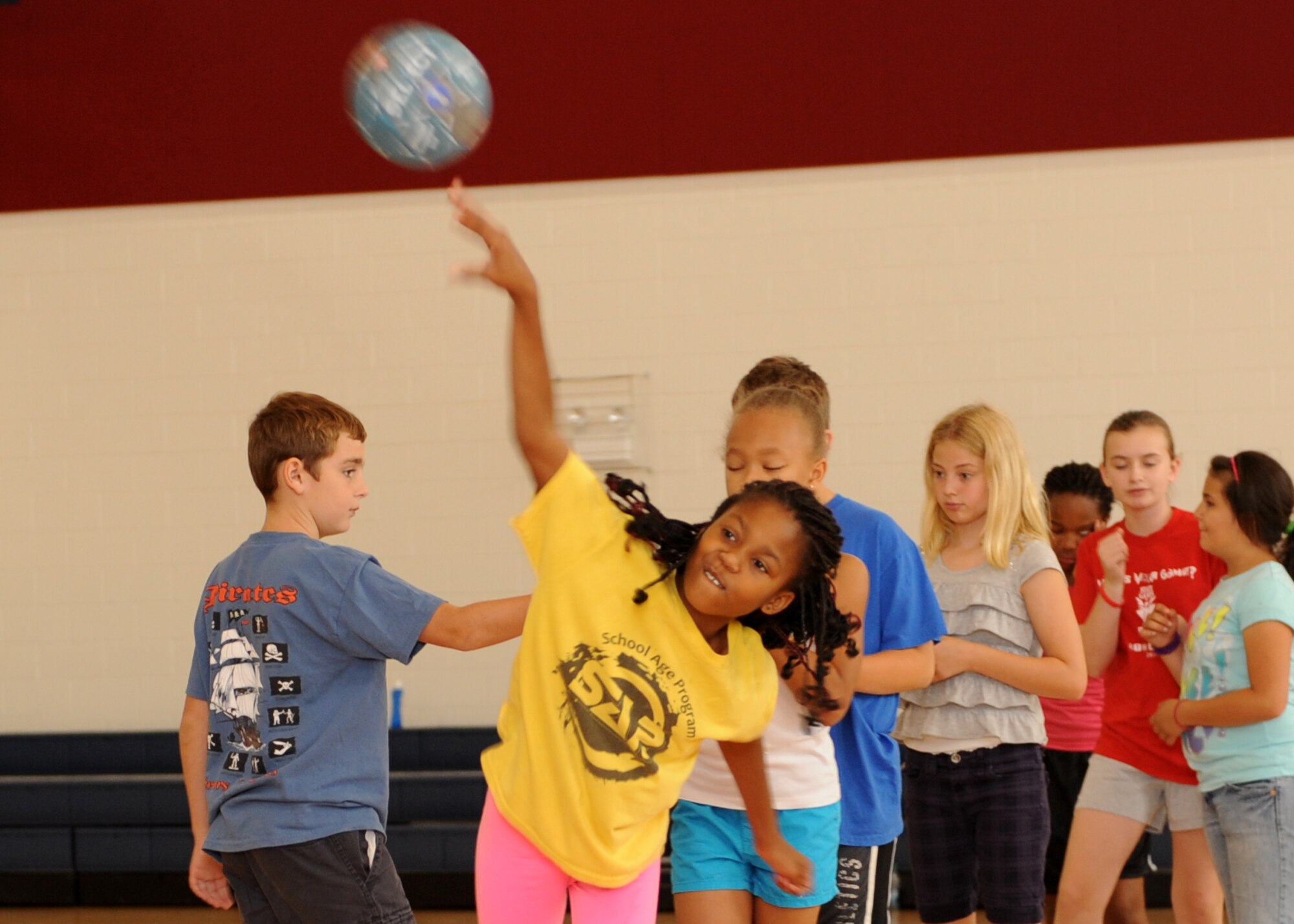 Azaria Edwards, daughter of Staff Sgt. Letitia Edwards, Air Force Reserve Command, throws a ball July 16, 2013, at the youth center on Buckley Air Force Base, Colo. The Sidelines Sports Camp gave children the opportunity to learn about a variety of unique sports. (U.S. Air Force photo by Senior Airman Marcy Glass/Released)
