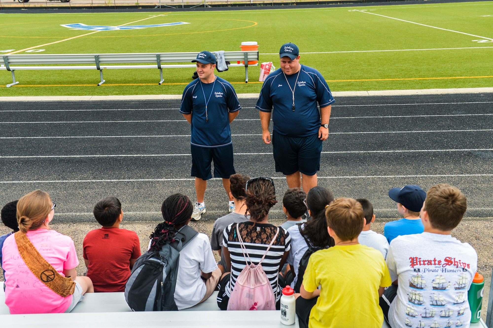 Daryl Howell, left, and Jonathan Craig, right, both Sidelines Sports Camp counselors, introduce themselves to the children participating in the sports camp July 15, 2013, on Buckley Air Force Base, Colo.  The goal of the camp was to expand and assist youths' understanding of different sports and an appreciation for those sports as a lifelong skill. (U.S. Air Force photo by Staff Sgt. Paul Labbe/Released)