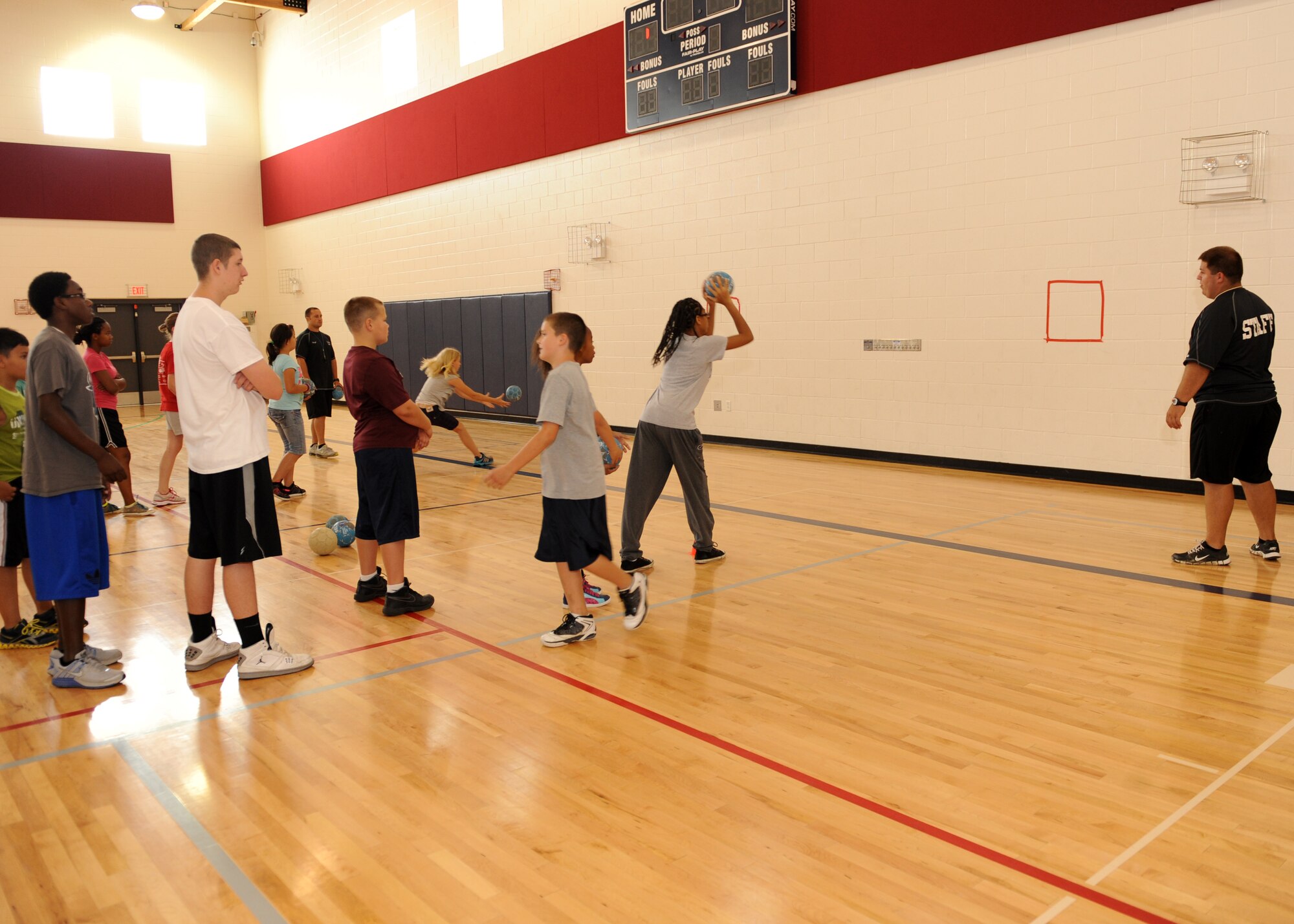 Youths throw hands balls at a wall target July 16, 2013, at the youth center on Buckley Air Force Base, Colo. Hosted by Sidelines Sports Camp, the camp invited children to learn about uncustomary sports and the rules of each game. (U.S. Air Force photo by Senior Airman Marcy Glass/Released)