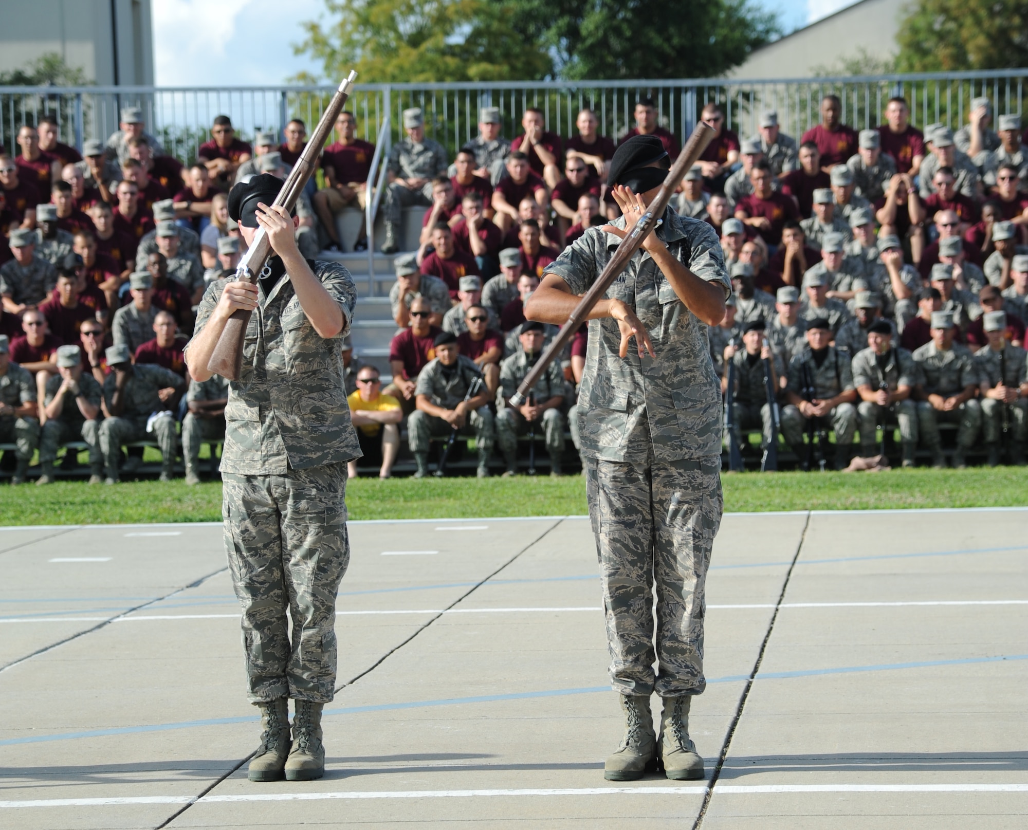 Airmen 1st Class Reed Lyons and Joshua Buchanan, 336th Training Squadron, perform exhibition armed drill blindfolded during the freestyle portion of the 81st Training Group drill down competition July 19, 2013, behind the Levitow Training Support Facility, Keesler Air Force Base, Miss.  (U.S. Air Force photo by Kemberly Groue)