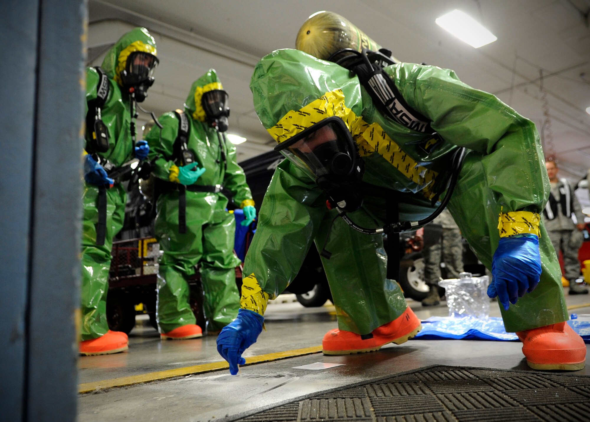 U.S. Air Force Senior Airman Sean Kirby, 354th Civil Engineer Squadron emergency management technician, collects a simulated suspicous powder to be tested during an operational readiness exercise at Eielson Air Force Base, Alaska, July 18, 2013. Emergency management technicians use specialized tools and chemicals to determine what type of hazardous substance exists. (U.S. Air Force photo by Senior Airman Shawn Nickel/Released)
