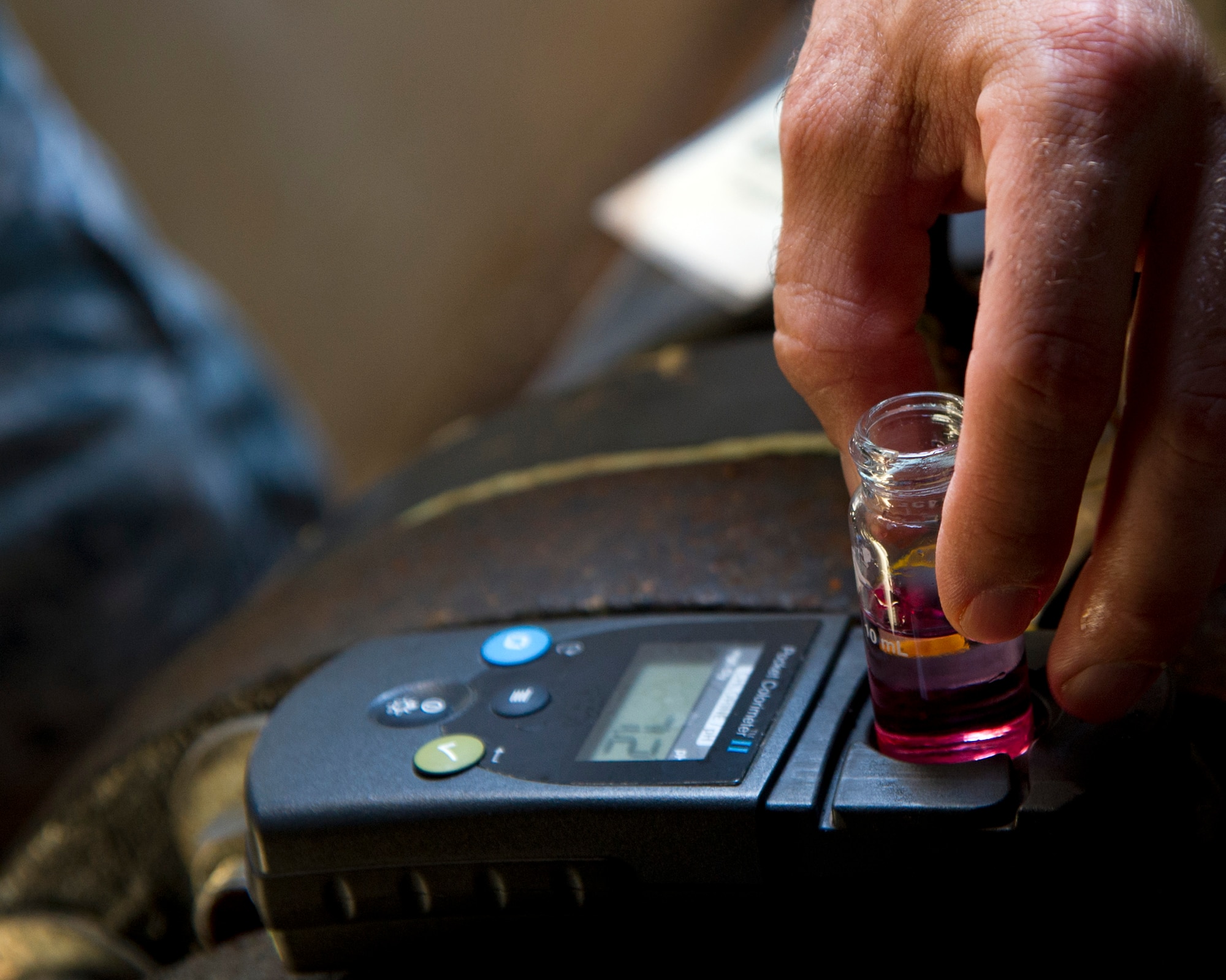 ALTUS AIR FORCE BASE, Okla. -- Staff Sgt. Marshall Varrato, 97th Medical Operations Squadron bioenvironmental engineering NCO in charge of readiness and training, removes a water sample from a testing machine during a routine water sampling at the main water line on base. Members of the 97th MDOS bioenvironmental engineering flight conduct water samplings twice a month. The samples are collected and then delivered to a lab in Elk City, Okla. where they are tested for contaminants. (U.S. Air Force photo by Senior Airman Kenneth W. Norman / Released)