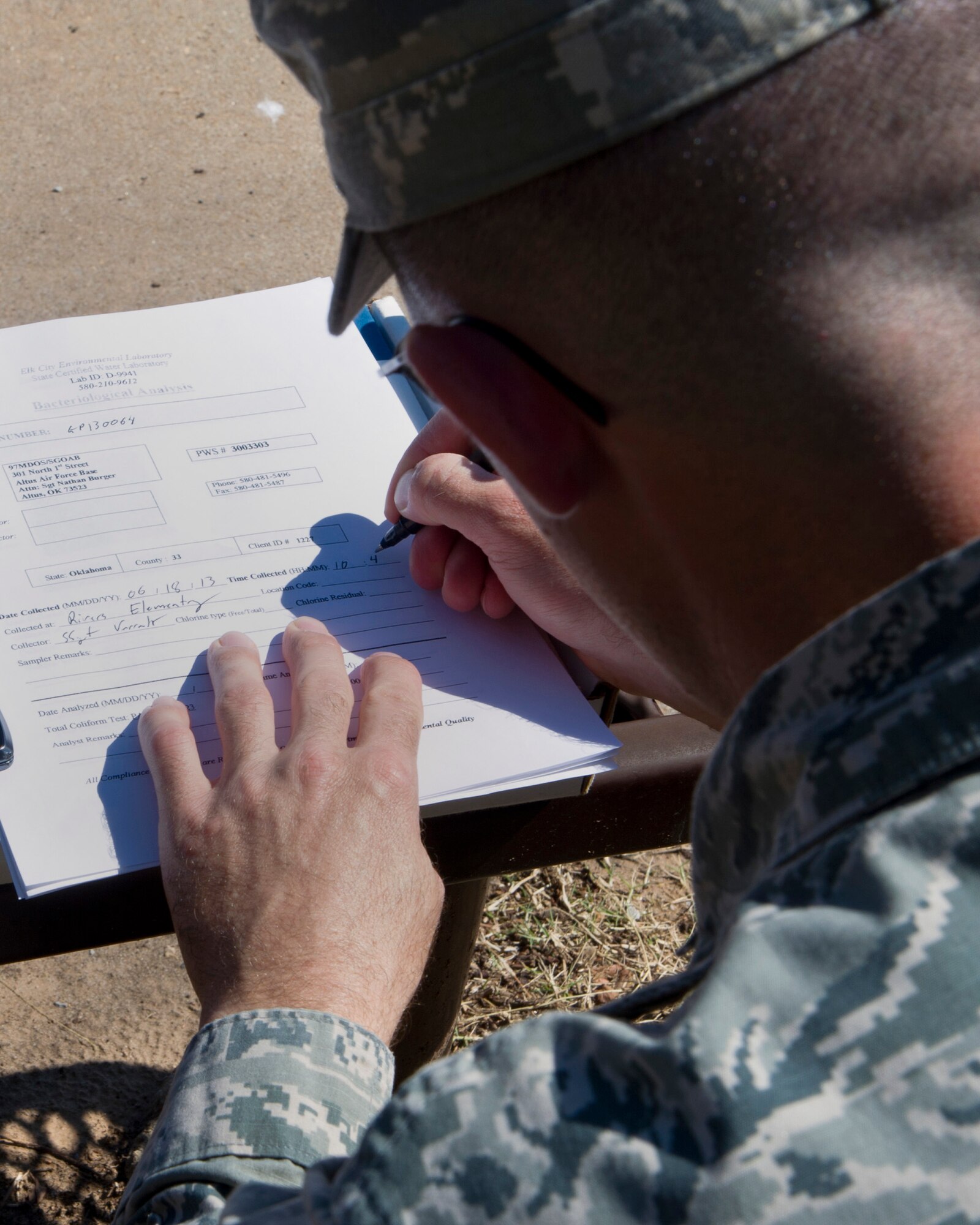 ALTUS AIR FORCE BASE, Okla. -- Staff Sgt. Marshall Varrato, 97th Medical Operations Squadron bioenvironmental engineering NCO in charge of readiness and training, fills out a bacteriological analysis form during a routine water sampling at Rivers Elementary School. Members of the 97th MDOS bioenvironmental engineering flight conduct water samplings twice a month. The samples are collected and then delivered to a lab in Elk City, Okla. where they are tested for contaminants. (U.S. Air Force photo by Senior Airman Kenneth W. Norman / Released)