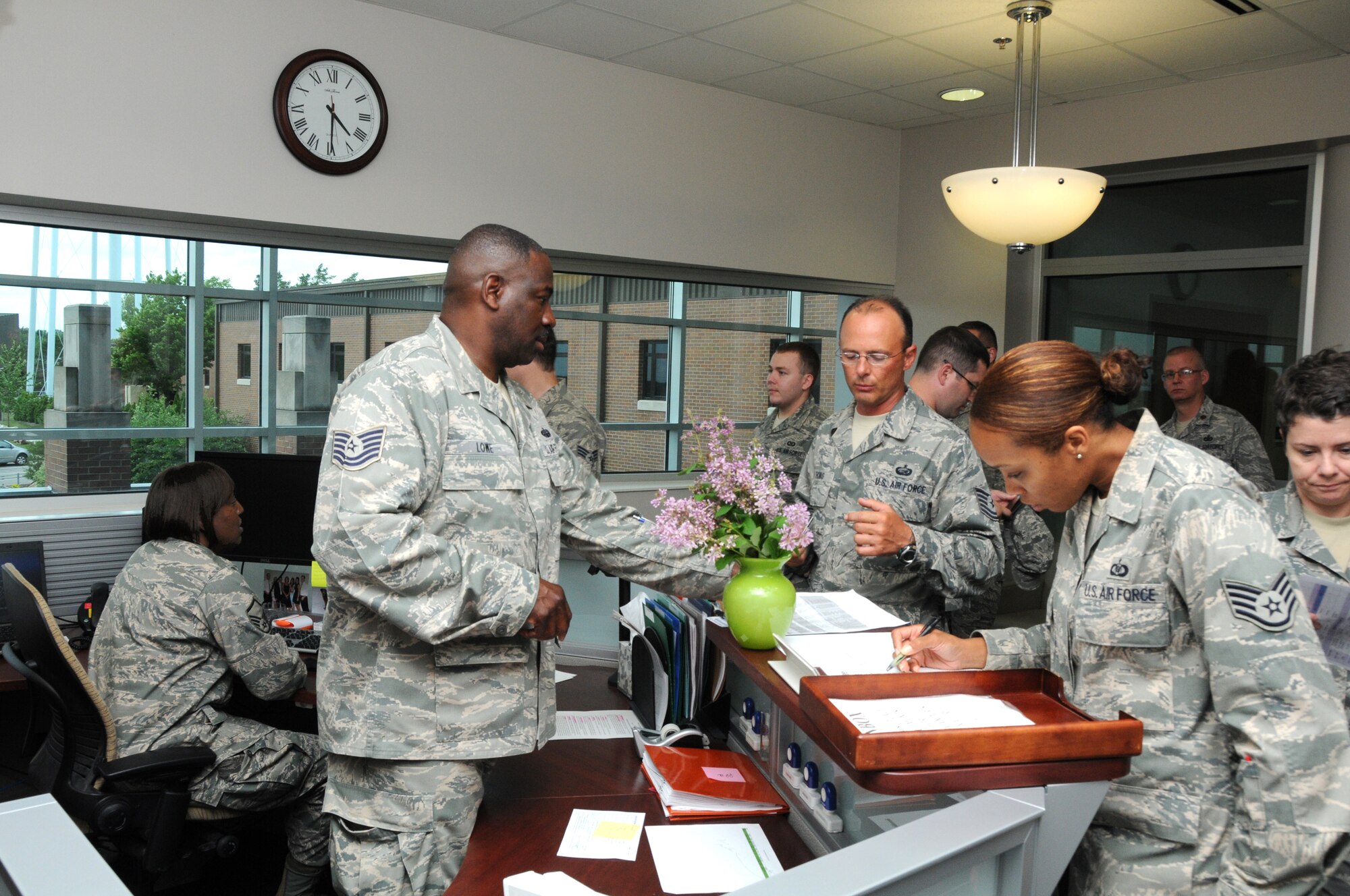 Youngstown Air Reserve Station, Ohio--Master Sgt. Pamela Fitzgerald and Technical Sgt. Princeton Lowe, Administration Specialists with the 910 Airlift Wing, assist members of the 910th Airlift Wing as they sign out at the end of a training day. (U.S. Air Force photo/ TSgt Rick Lisum)
