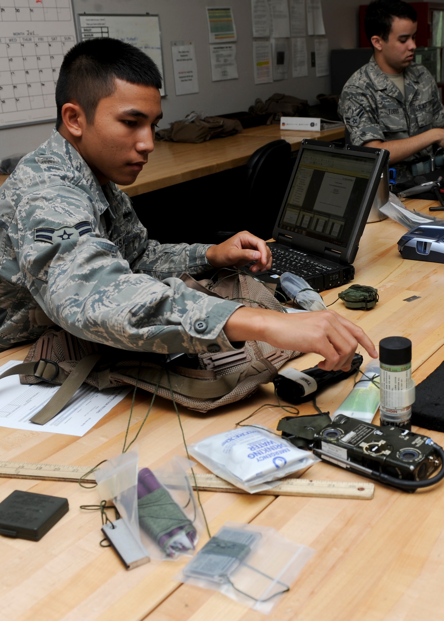 Airman 1st Class Jorome Cruz, 37th Bomb Squadron aircrew flight equipment technician, inspects a survival vest while performing equipment checks at Ellsworth Air Force Base, S.D., July 16, 2013. Survival vests are inspected every two months ensuring that all supplies are accounted for and are up-to-date to maintain readiness for aircrew members who need this equipment in emergency situations. (U.S. Air Force photo by Airman 1st Class Anania Tekurio/Released) 