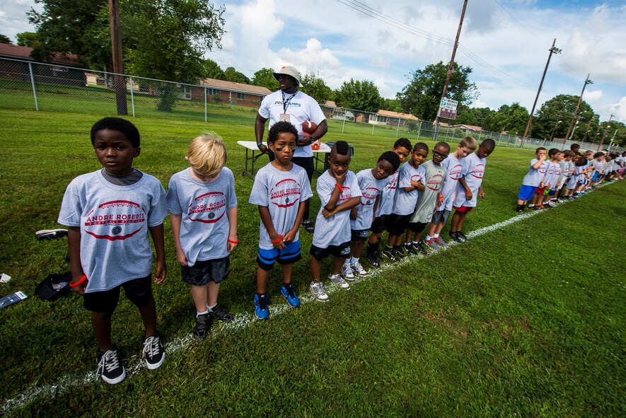 Children line up for a drill during the Andre Roberts Pro Camp July 15, 2013, at Joint Base Charleston - Weapons Station, S.C. More than 100 base children attended the camp held July 15-16, and were able to participate in fundamental football drills. Small groups ensured each camper received maximum instruction from the area’s top football coaches. Roberts funded the camp, enabling children to attend for free.  (U.S. Air Force photo/ Senior Airman George Goslin)
