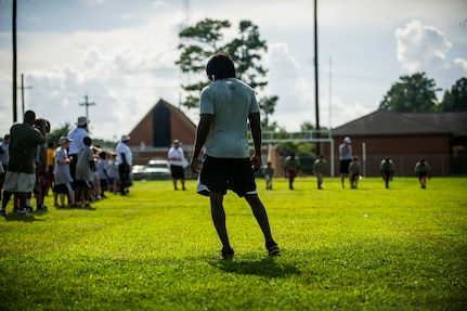 Andre Roberts, Arizona Cardinals wide receiver, waits at the 40 yard dash finish line to judge the winners during the Andre Roberts Pro Camp, July 15, 2013, at Joint Base Charleston - Weapons Station, S.C. More than 100 base children attended the Andre Roberts Pro Camp on July 15-16. The camp was paid for by Roberts, enabling the children to attend for free. (U.S. Air Force photo/ Senior Airman George Goslin)