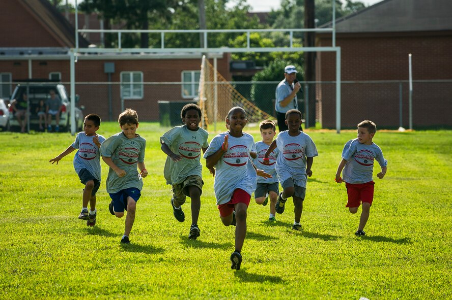 Children run a 40-yard dash during the Andre Roberts Pro Camp July 15, 2013, at Joint Base Charleston - Weapons Station, S.C. More than 100 base children attended the camp held July 15-16, and were able to participate in fundamental football drills. Small groups ensured each camper received maximum instruction from the area’s top football coaches. Roberts funded the camp, enabling children to attend for free.  (U.S. Air Force photo/ Senior Airman George Goslin)