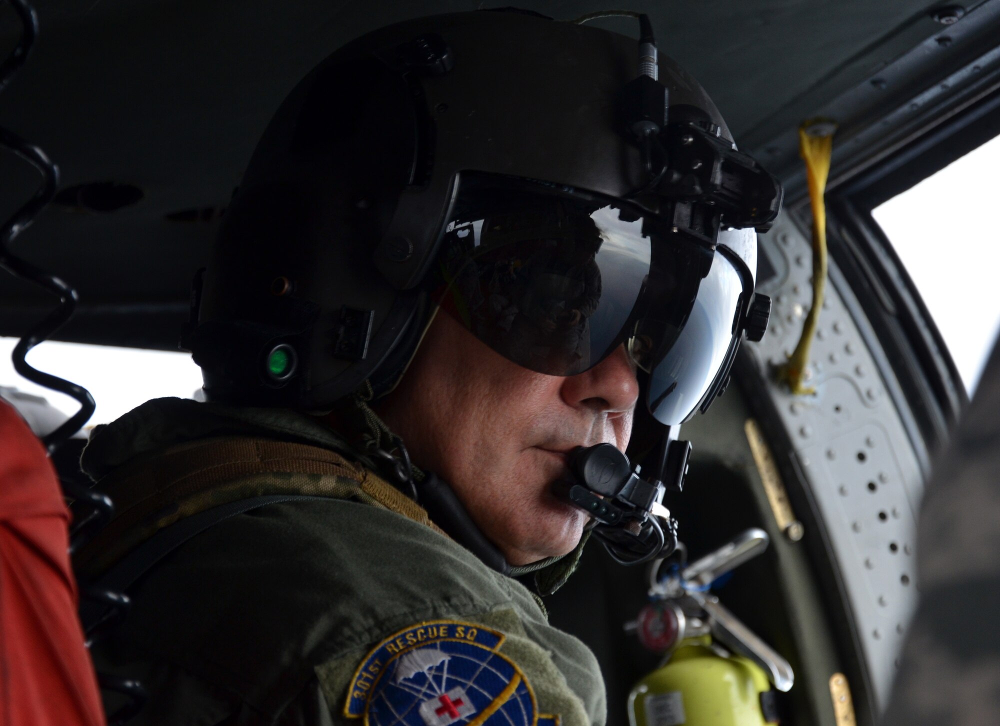 Chief Master Sgt. Lazaro Ibarra, a flight engineer with the 920th Rescue Wing, Patrick Air Force Base, Fla., helps clear the range prior to the launch of an Atlas V rocket from Cape Canaveral Air Force Station, Fla. (U.S. Air Force photo/Tech. Sgt. Anna-Maire Wyant)