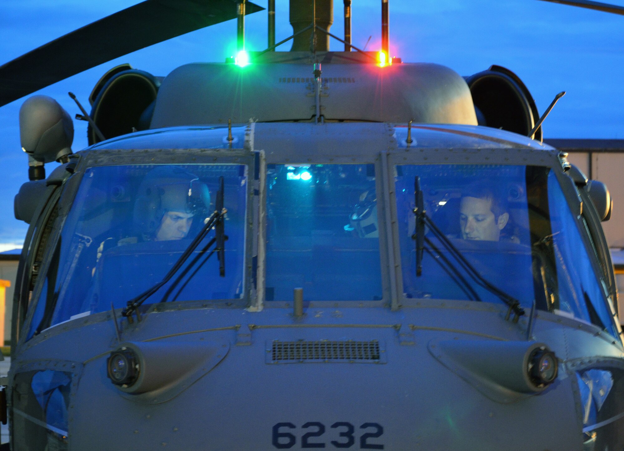 Lt. Col. Robert Haston and Capt. Jason Tomas, 920th Rescue Wing Pave Hawk helicopter pilots at Patrick Air Force Base, Fla., prepare to fly over Florida’s Atlantic Coast to provide range clearing support for the Atlas V rocket launch July 19, 2013, Cape Canaveral Air Force Station, Fla. (U.S. Air Force photo/Tech. Sgt. Anna-Maire Wyant)