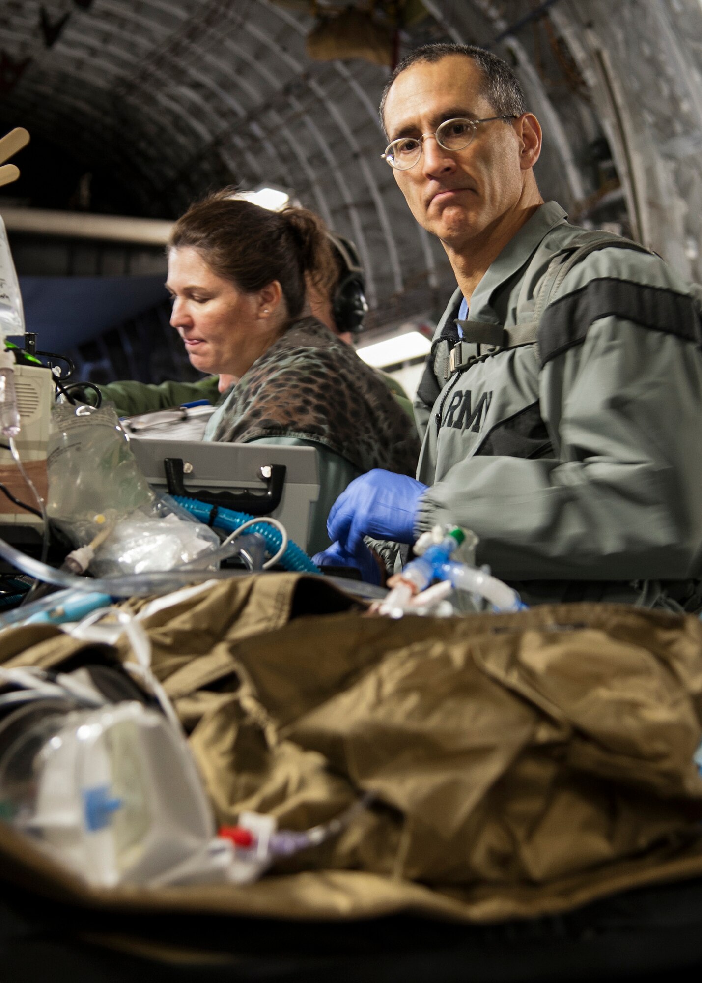 U.S. Air Force Lt. Col. (Dr.) Jeremy Cannon treats an extracorporeal membrane oxygenation patient on a C-17 Globemaster III, Jan. 16, Joint Base San Antonio-Lackland, Texas. The patient was the first to be air-transferred on an ECMO machine this year. (U.S. Air Force photo/Staff Sgt. Kevin Iinuma)