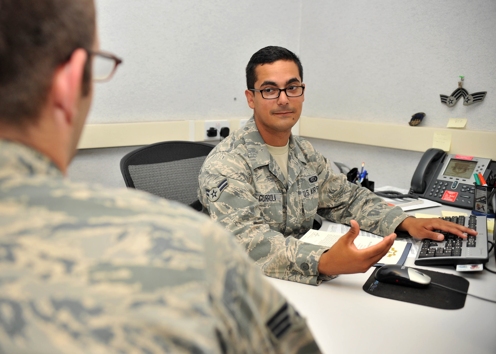 Airman 1st Class Xavier Gurrola, 100th Force Support Squadron force management apprentice from Covina, Calif., assists a customer July 19, 2013, on RAF Mildenhall, England. Gurrola was selected to be featured in this week’s Square D Spotlight for demonstrating the Air Force core value service before self. (U.S. Air Force photo by Staff Sgt. Jerilyn Quintanilla/Released)