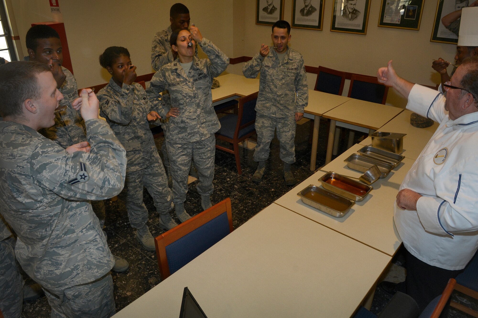 Airmen from the 31st Force Support Squadron sample different flavors during a taste testing July 17, 2013, at the La Dolce Vita dining facility on Aviano Air Base, Italy. Chef consultant Carlos Sierra gave a presentation on culinary techniques including different ways to cut vegetables, how to properly handle a knife and how to garnish a plate or tray. (U.S. Air Force photo/Senior Airman Jessica Hines)