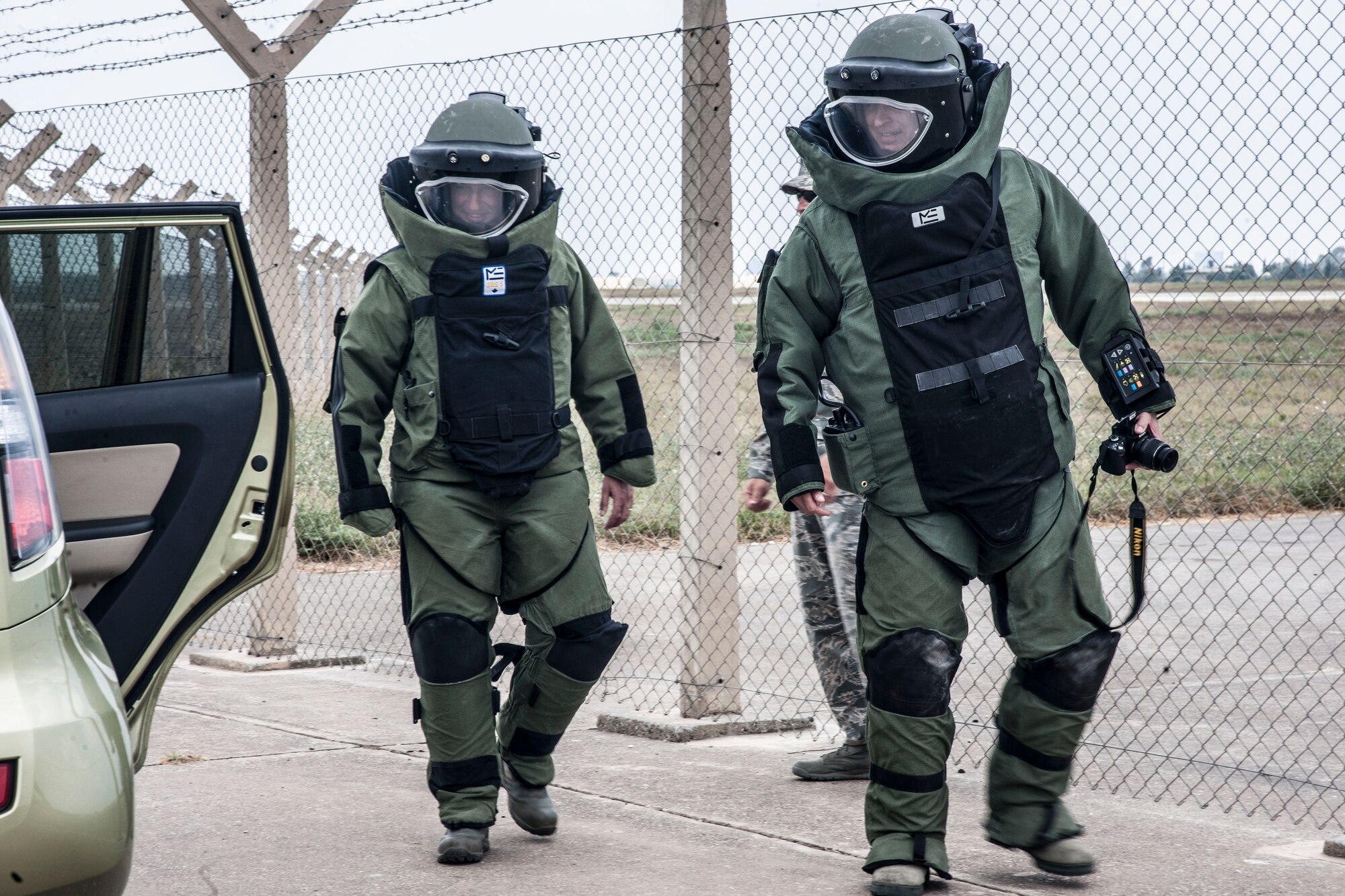 Col. Craig Wills, 39th Air Base Wing commander, right, and Maj. Matthew Welling, 39th Civil Engineer Squadron commander, look for simulated unexploded ordnance while wearing bomb suits during the wing commander’s immersion with the 39th CES explosive ordnance disposal flight July 18, 2013, at Incirlik Air Base, Turkey. Wills and Welling discovered the hidden training “threat” the EOD flight had set up for them. (U.S. Air Force photo by Senior Airman Anthony Sanchelli/Released)
