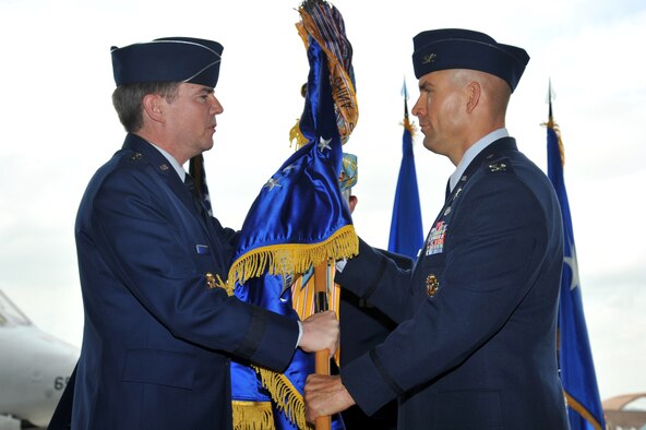 Lt. Gen. Jan-Marc Jouas, 7th Air Force commander, transfers command of the 51st Fighter Wing to Col. Brook Leonard during a change of command ceremony at Osan Air Base, Republic of Korea, July 19, 2013.  As commander he is responsible for ensuring the wing is ready to defend Osan Air Base, execute combat operations, and receive follow-on forces. (U.S. Air Force photo/Staff Sgt. Emerson Nuñez)