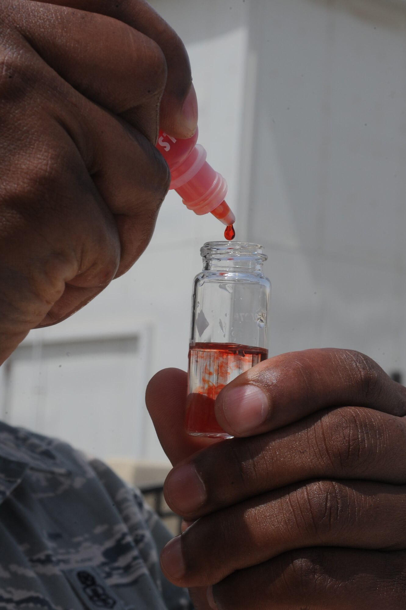 U.S. Air Force Master Sgt. Nathan Hanzy, 380th Expeditionary Medical Group NCO in charge of preventive medicine, checks the base pool for the proper amount of chlorine at an undisclosed location in Southwest Asia July 16, 2013. Hanzy inspects 20 different facilities. Hanzy is native to Gray, La., and is deployed from Offutt Air Force Base, Neb. (U.S. Air Force photo by Staff Sgt. Joshua J. Garcia)
