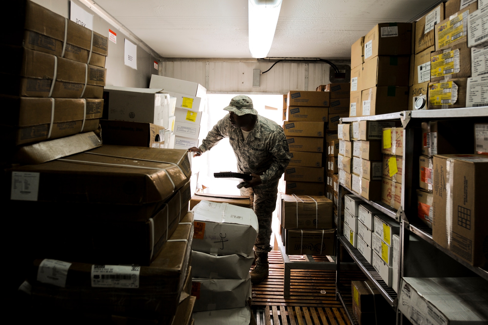 U.S. Air Force Master Sgt. Nathan Hanzy, 380th Expeditionary Medical Group NCO in charge of preventive medicine, checks expiration dates on cold food products at a dining facility during a random facility inspection at an undisclosed location in Southwest Asia July 16, 2013. Hanzy inspects the facilities bi-weekly and ensures Food and Drug Administration standards are met. Hanzy is native to Gray, La., and is deployed from Offutt Air Force Base, Neb. (U.S. Air Force photo by Staff Sgt. Joshua J. Garcia)
