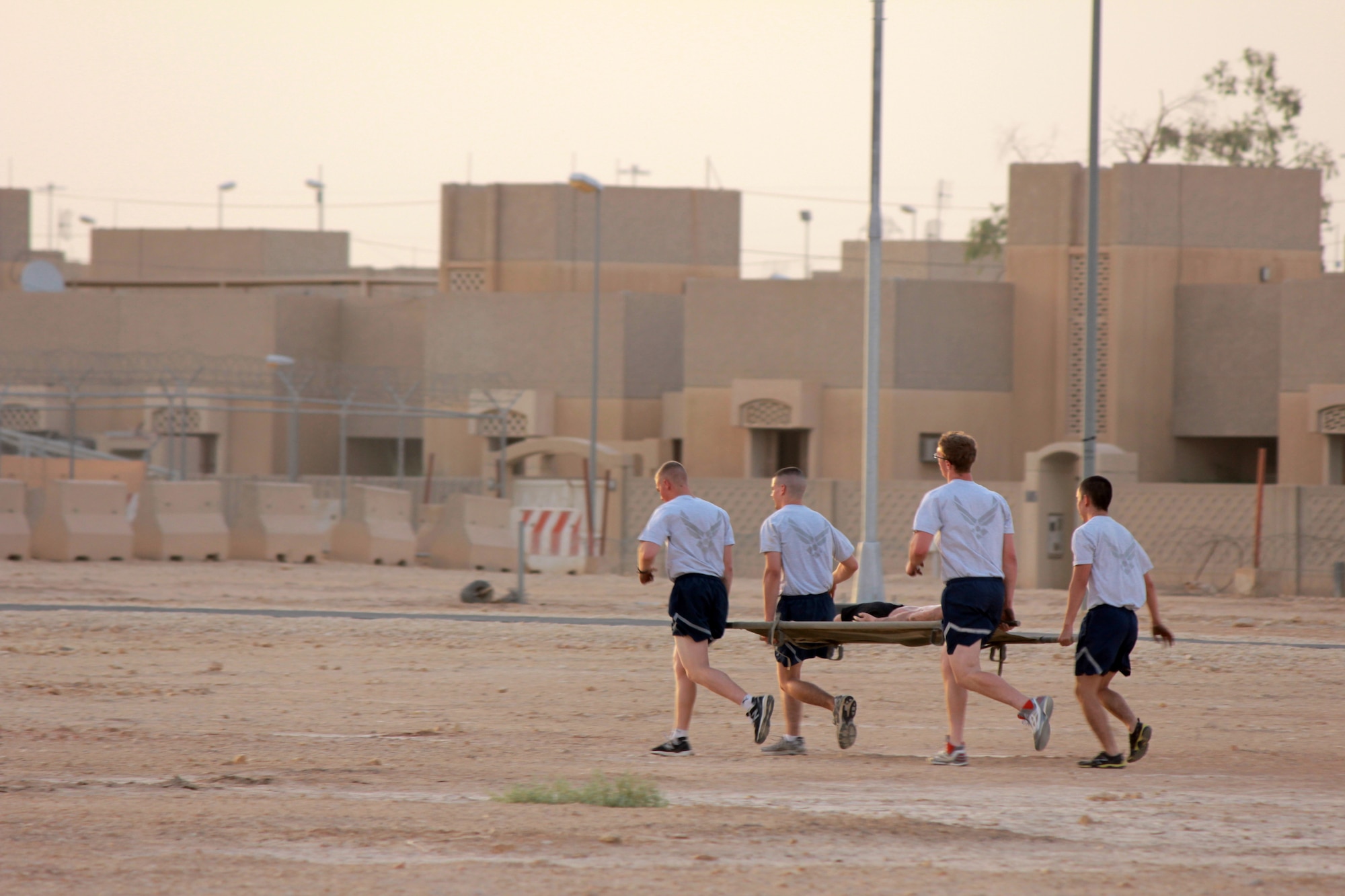 Airmen from the 64th Expeditionary Security Forces Squadron perform a litter carry during a combat obstacle course at the 64th Air Expeditionary Group in Southwest Asia, June 28, 2013. The course was part of a three-day Commander’s Cup Challenge consisting of 10 events testing not only participant’s physical capabilities, but also their professional military knowledge. (Courtesy photo) 