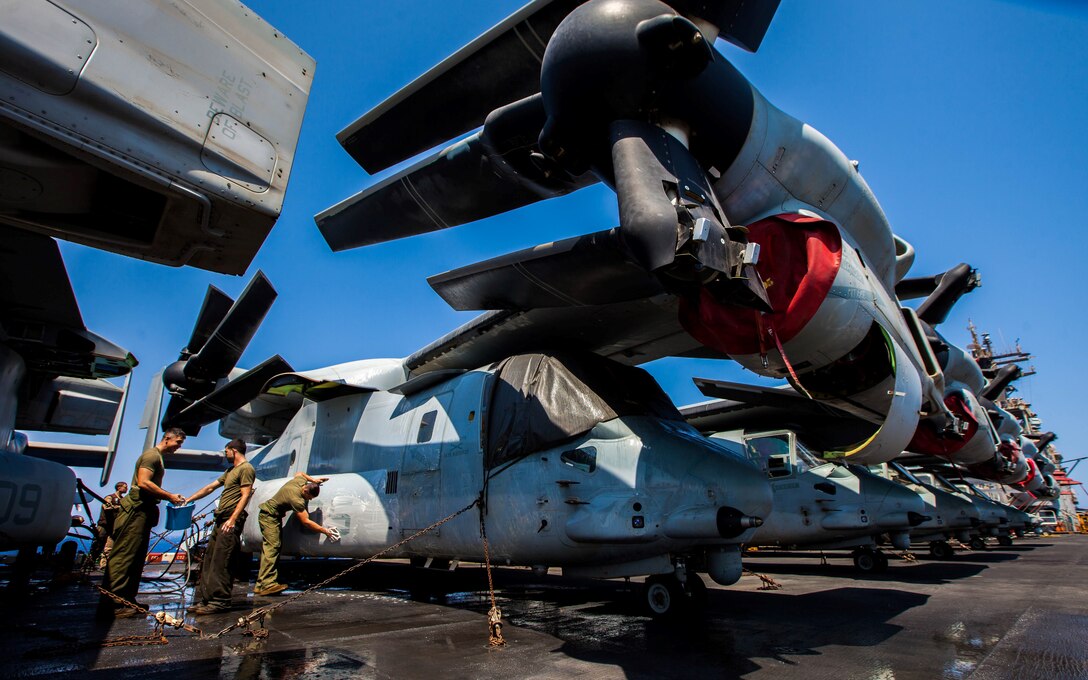 U.S. Marine Corps MV-22B Osprey crew chiefs and mechanics assigned to Marine Medium Tiltrotor Squadron (VMM) 266 (Reinforced), 26th Marine Expeditionary Unit (MEU), wash their aircraft on the flight deck of the USS Kearsarge (LHD 3), at sea, July 20, 2013. The 26th MEU is a Marine Air-Ground Task Force forward-deployed to the U.S. 5th Fleet area of responsibility aboard the Kearsarge Amphibious Ready Group serving as a sea-based, expeditionary crisis response force capable of conducting amphibious operations across the full range of military operations. (U.S. Marine Corps photo by Sgt. Christopher Q. Stone, 26th MEU Combat Camera/Released)