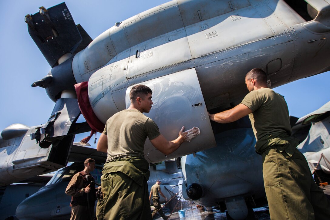 U.S. Marine Corps MV-22B Osprey crew chiefs and mechanics assigned to Marine Medium Tiltrotor Squadron (VMM) 266 (Reinforced), 26th Marine Expeditionary Unit (MEU), wash their aircraft on the flight deck of the USS Kearsarge (LHD 3), at sea, July 20, 2013. The 26th MEU is a Marine Air-Ground Task Force forward-deployed to the U.S. 5th Fleet area of responsibility aboard the Kearsarge Amphibious Ready Group serving as a sea-based, expeditionary crisis response force capable of conducting amphibious operations across the full range of military operations. (U.S. Marine Corps photo by Sgt. Christopher Q. Stone, 26th MEU Combat Camera/Released)