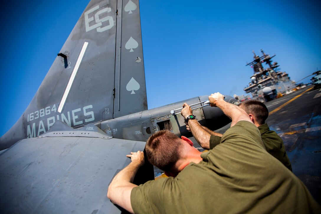 U.S. Marine Corps Cpl. Cody Hill, native of Rome, Ga., left, and Lance Cpl. Derek Dwire, native of Somerset, Pa., right, both AV-8B Harrier airframe mechanics assigned to Marine Medium Tiltrotor Squadron (VMM) 266 (Reinforced), 26th Marine Expeditionary Unit (MEU), perform general maintenance on their aircraft on the flight deck of the USS Kearsarge (LHD 3), at sea, July 20, 2013. The 26th MEU is a Marine Air-Ground Task Force forward-deployed to the U.S. 5th Fleet area of responsibility aboard the Kearsarge Amphibious Ready Group serving as a sea-based, expeditionary crisis response force capable of conducting amphibious operations across the full range of military operations. (U.S. Marine Corps photo by Sgt. Christopher Q. Stone, 26th MEU Combat Camera/Released)