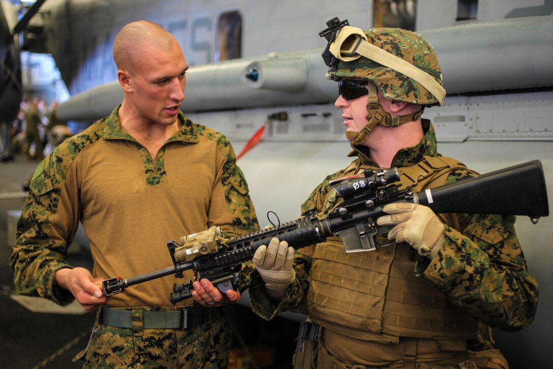 Corporal Brent S. Berven, a squad leader for Company E., Battalion Landing Team 2nd Battalion, 4th Marines, 31st Marine Expeditionary Unit, and a native of Folsom, Calif., ensures the blank firing adapter is secured on the rifle of Lance Cpl. Brian C. Keen, an assistant infantry automatic weapon gunner for Co. E., BLT 2/4, 31st MEU, and a native of York, Penn., during a gear inspection prior to a vertical assault here, July 20. The Marines and Sailors of the 31st MEU and Amphibious Squadron 11 are part of an integrated force of approximately 18,000 U.S. service members training alongside approximately 9,000 Australian service members in the fifth iteration of Talisman Saber 2013, a month-long biennial exercise designed to enhance multilateral collaboration in support of future combined operations, natural disaster, humanitarian and emergency response. The 31st MEU is the Marine Corps’ force in readiness for the Asia Pacific region and the only continuously forward-deployed MEU.