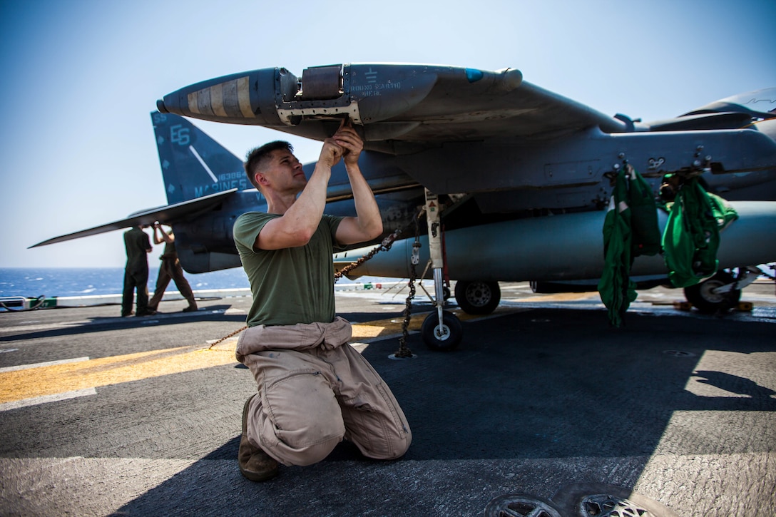 U.S. Marine Corps Sgt. Johnathan Davis, native of Mattoon, Ill., an AV-8B Harrier airframe mechanic assigned to Marine Medium Tiltrotor Squadron (VMM) 266 (Reinforced), 26th Marine Expeditionary Unit (MEU), performs general maintenance on his aircraft on the flight deck of the USS Kearsarge (LHD 3), at sea, July 20, 2013. The 26th MEU is a Marine Air-Ground Task Force forward-deployed to the U.S. 5th Fleet area of responsibility aboard the Kearsarge Amphibious Ready Group serving as a sea-based, expeditionary crisis response force capable of conducting amphibious operations across the full range of military operations. (U.S. Marine Corps photo by Sgt. Christopher Q. Stone, 26th MEU Combat Camera/Released)