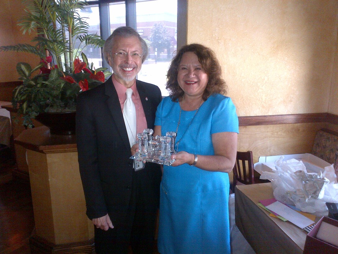Lillian Almodovar receives commemorative Corps Castle from IWR Director Bob Pietrowsky at a ceremony celebrating her retirement.