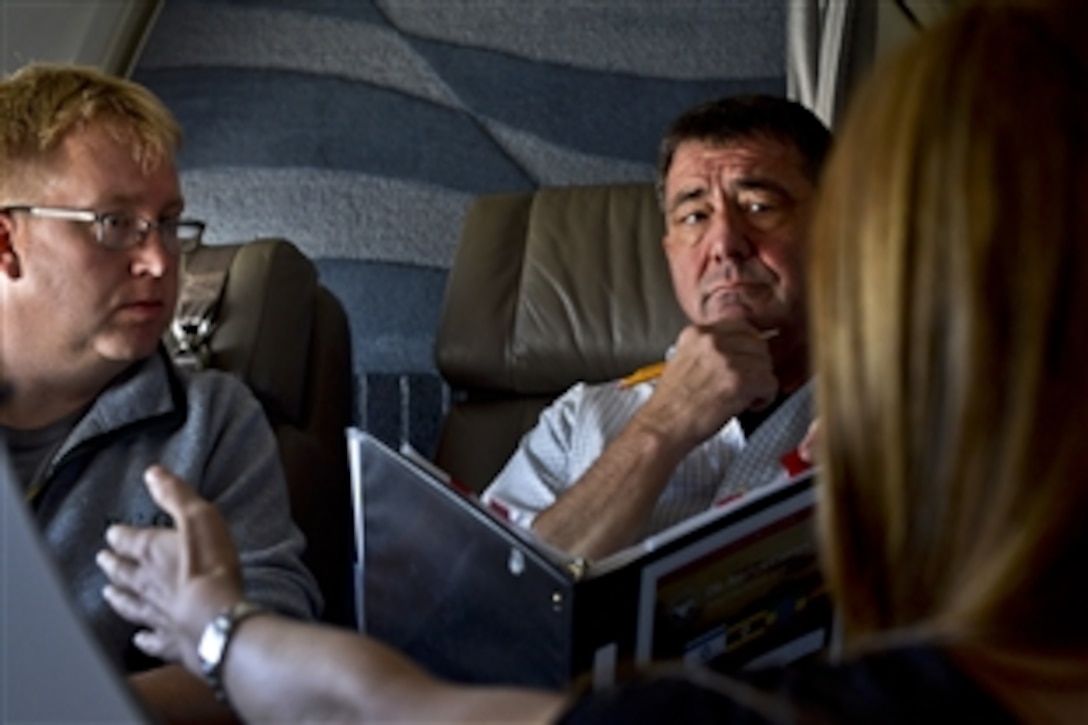 Deputy Defense Secretary Ash Carter and his staff prepare for a three-country trip while en route to Israel aboard a military aircraft, July 20, 2013. Carter also is scheduled to travel to Uganda and Ethiopia in sub-Saharan Africa. During his trip, he will meet with defense and government leaders to discuss issues of mutual importance.