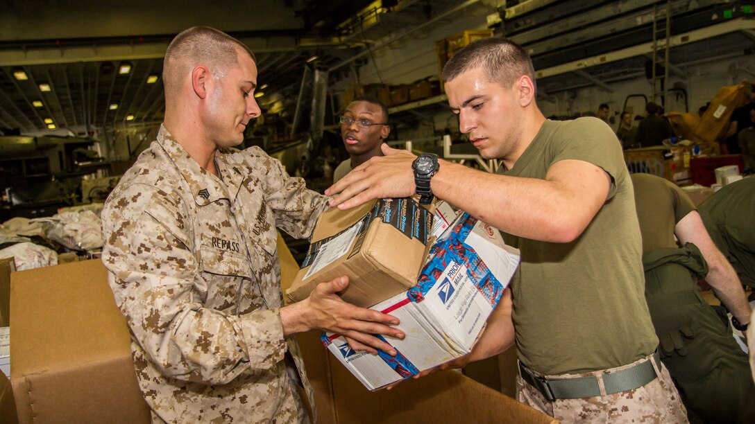 U.S. Marines assigned to 26th Marine Expeditionary Unit (MEU), sort mail in the hanger bay of the USS Kearsarge (LHD 3) after a resupply at sea, July 20, 2013. The ship received 136 pallets of mail, the largest shipment on this deployment. The 26th MEU is a Marine Air-Ground Task Force forward-deployed to the U.S. 5th Fleet area of responsibility aboard the Kearsarge Amphibious Ready Group serving as a sea-based, expeditionary crisis response force capable of conducting amphibious operations across the full range of military operations. (U.S. Marine Corps photo by Sgt. Christopher Q. Stone, 26th MEU Combat Camera/Released)