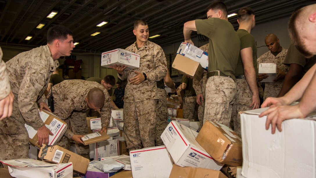 U.S. Marines assigned to 26th Marine Expeditionary Unit (MEU), sort mail in the hanger bay of the USS Kearsarge (LHD 3) after a resupply at sea, July 20, 2013. The ship received 136 pallets of mail, the largest shipment on this deployment. The 26th MEU is a Marine Air-Ground Task Force forward-deployed to the U.S. 5th Fleet area of responsibility aboard the Kearsarge Amphibious Ready Group serving as a sea-based, expeditionary crisis response force capable of conducting amphibious operations across the full range of military operations. (U.S. Marine Corps photo by Sgt. Christopher Q. Stone, 26th MEU Combat Camera/Released)